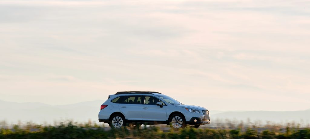 SUV driving on open road representing Montana vehicle registration for business and fleet use