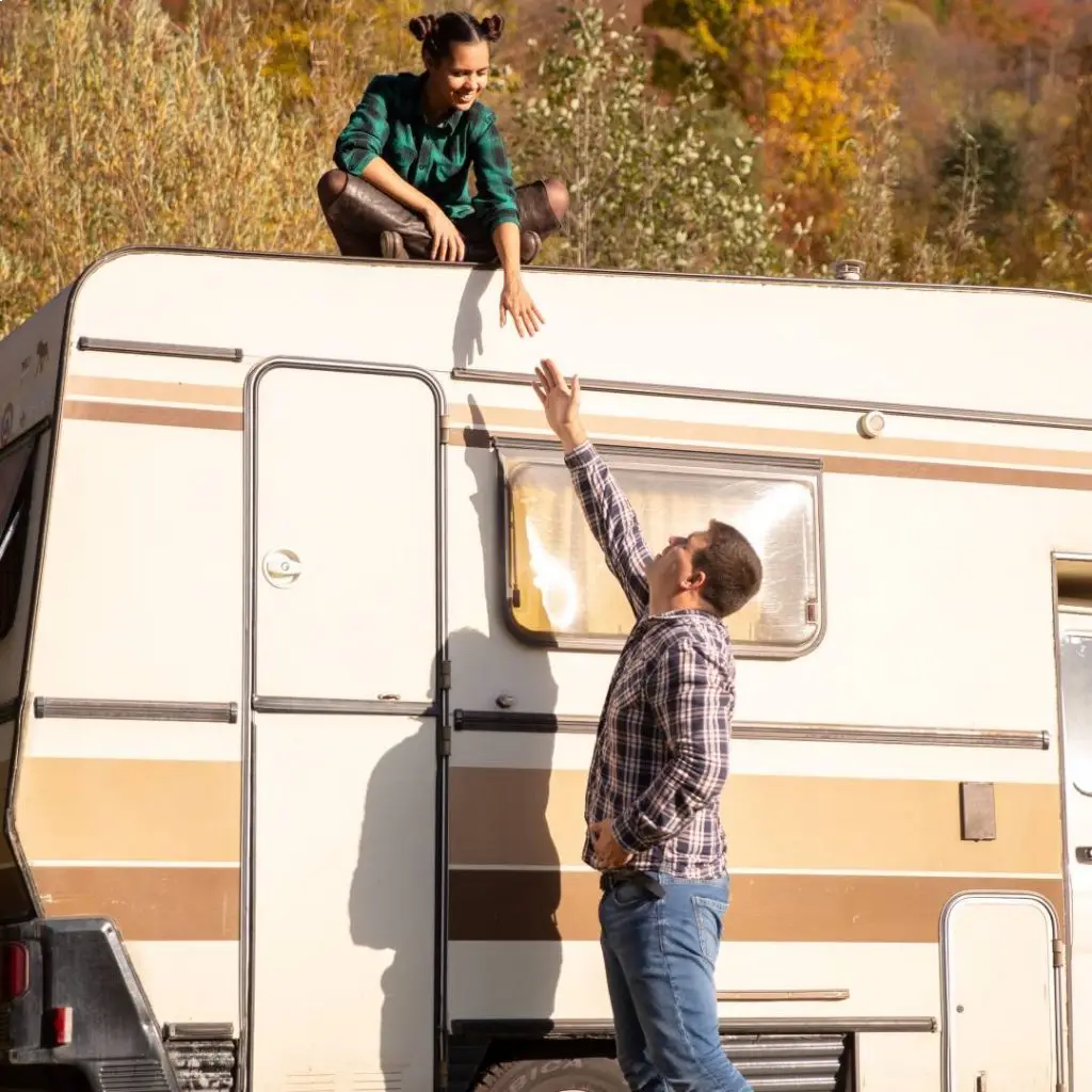 A couple enjoying their RV outdoors, prompting the question: “Why register your RV in Montana?” for potential tax and registration benefits.