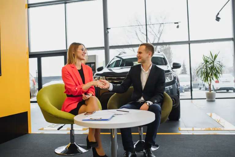 business clients completing vehicle registration transaction with dealership representative for Montana processing